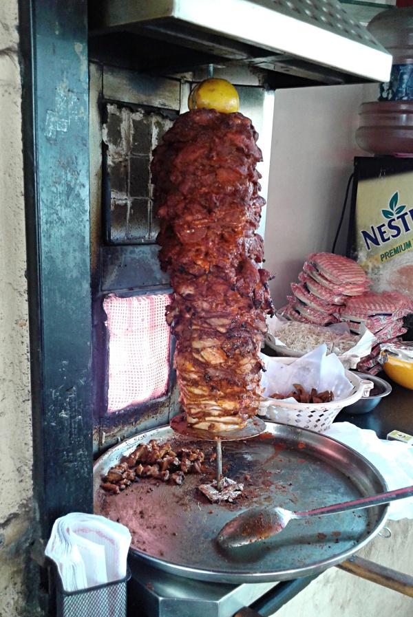 Shawarma Chicken Cooking on a Vertical Rotisserie at Al Bake